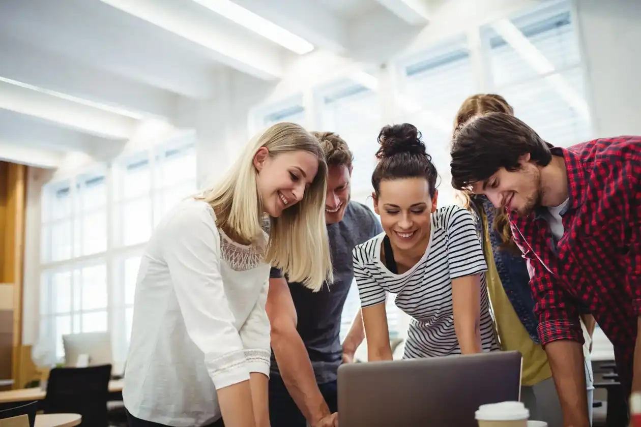 5 people looking at a computer